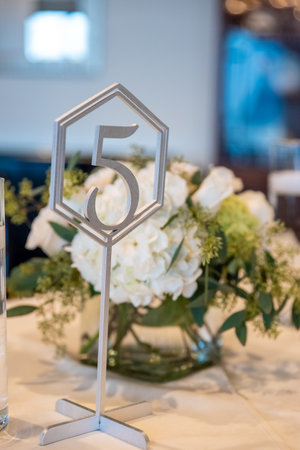A vertical shot of numbered wedding table settings with beautiful floral decorationsの写真素材
