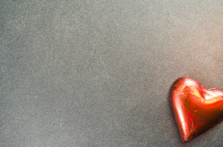 A top view of a red heart on a rough textured background with copy spaceの写真素材