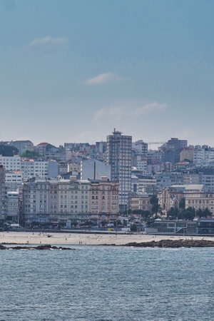 A vertical morning view of the buildings on the shore of the sea in Coruna, Galicia, Spainの写真素材