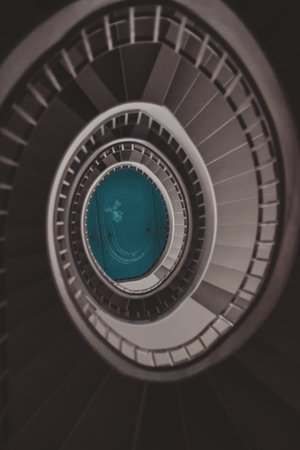 A high angle shot of tall spiral stairs inside a building