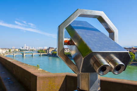 A closeup of a landscape telescope with the Rhine river on the background in Basel in Switzerlandの写真素材