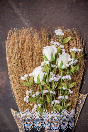A vertical closeup shot of a beautiful elegant wedding broom on the ground