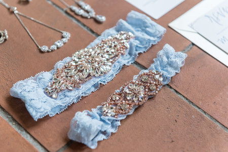 A closeup shot of accessories with precious stones on light blue laces