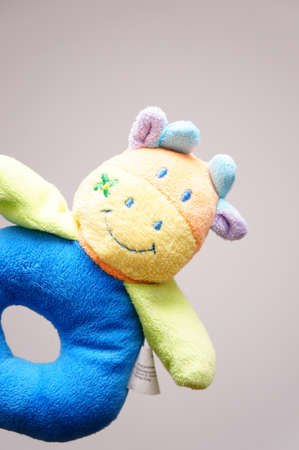 A vertical shot of a multicolored cow toy for children behind a white backgroundの写真素材