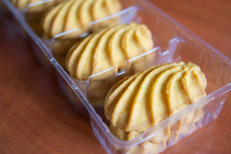 A close up shot of some fresh baked cookies in a plastic box