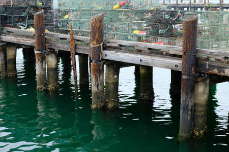 An old wooden pier with a lot of metal cagesの写真素材