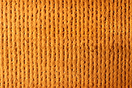 A closeup shot of a textured orange background