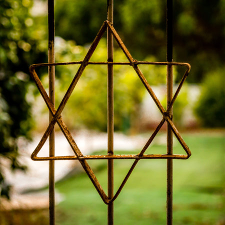 A selective focus closeup shot of the Star of David on a metal fence