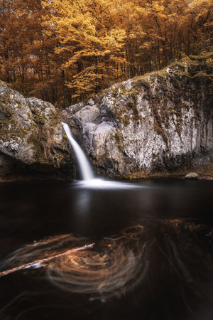A vertical shot of the waterfall Gumberdjiata in Rhodope mountain near Belitsa village, Bulgaria