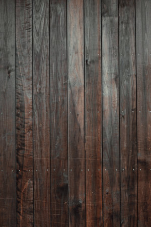 A vertical closeup shot of a wooden floor with dark brown vertical tilesの写真素材