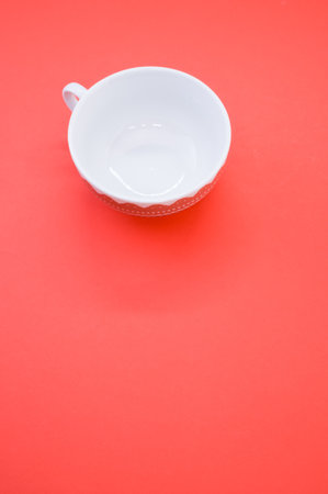 A vertical shot of cup isolated on red background