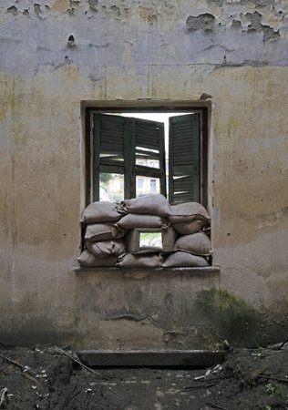 A lot of sandbags at the windows of an abandoned house in the buffer zone green line in Nicosia, Cyprusの写真素材