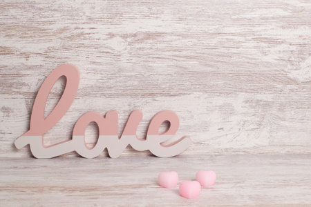 A small decoration with the word love and candies with heart shapeの写真素材