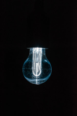 A closeup shot of an illuminated lamp on a black backgroundの写真素材