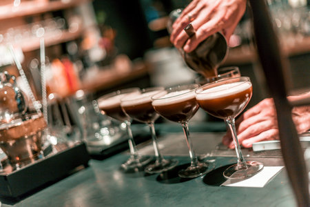 The bartender making an alcoholic cocktail, a summer cocktail in the bar