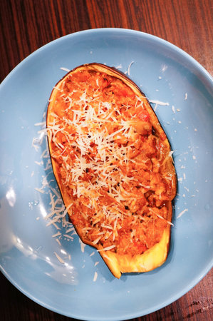 A top view of traditional food made of pumpkin and cheese on a blue plateの写真素材