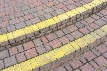 A closeup shot of cobblestone with grass growingの写真素材