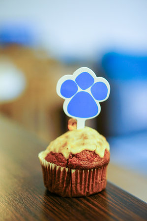 A closeup shot of a homemade chocolate muffin with a palm sticker on topの写真素材