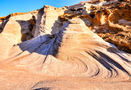 The sandy rocks illuminated by the sunlight on a hot day in summer