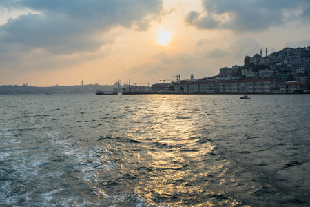 The sea surrounded by hills covered in buildings under the sunlight in Istanbul in Turkeyの写真素材
