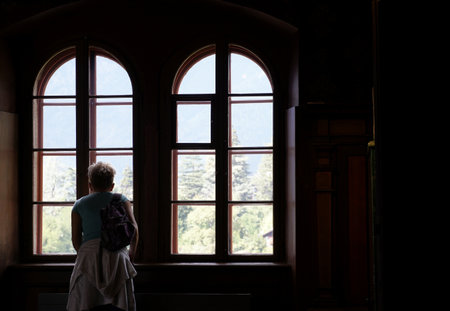 A tourist looking through the windows of Trautsmandorf Castle in Merano, Italyの写真素材