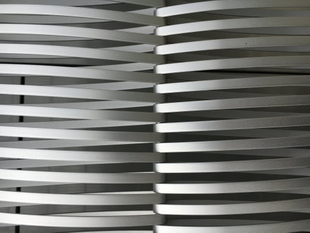A vertical shot of long white metal pieces next to each other