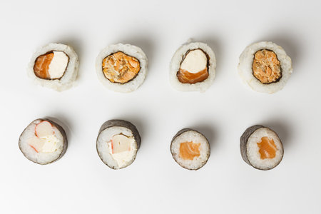 A top view of fresh sushi rolls on white backgroundの写真素材