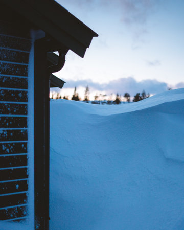 A closeup shot of the side of a small house in a snowy area in Norwayの写真素材