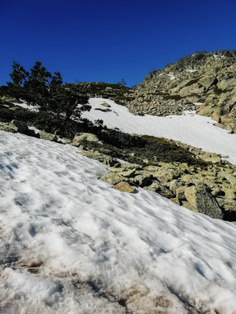 The mesmerizing view of the Penalara mountain in Spain covered in snow on a sunny day
