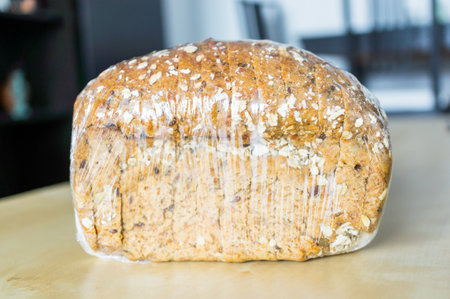 A closeup shot of brown bread packaged on a tableの写真素材