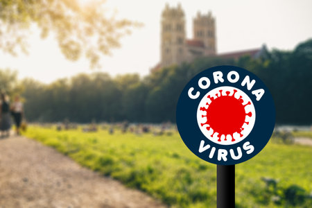 Coronavirus (Covid-19) concept. Blurred background of sunset at munich Isar river with people walking sitting cycling and enjoying summer eveningの写真素材