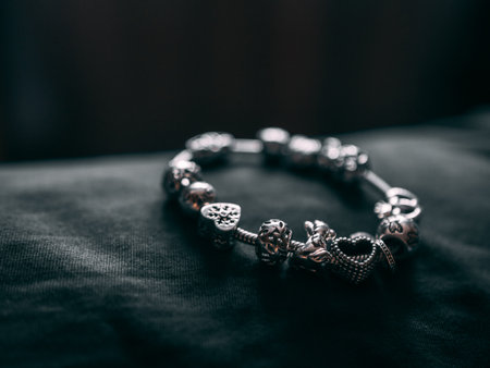 A closeup shot of a metal bracelet on a black surfaceの写真素材