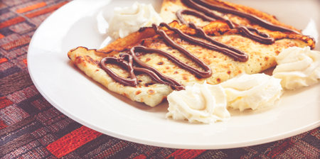 Pancake with chocolate served on a plate.の写真素材