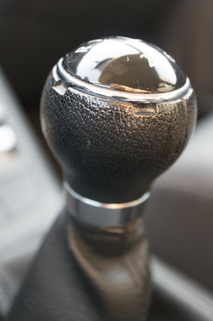 A closeup of the leather part of the gear shift of the car on a blurry backgroundの写真素材