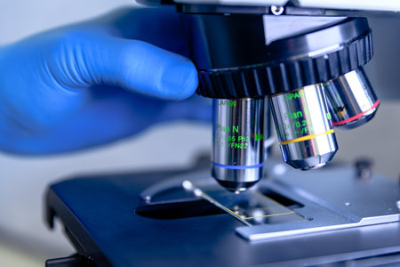 A closeup shot of laboratory microscope lens for conducting coronavirus research