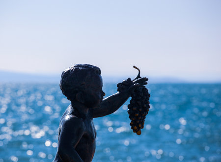 Pomorie, Bulgaria - February 07, 2020: "The Boy with Grapes" - The Statue Symbol Of The Town Of Pomorie.のeditorial素材