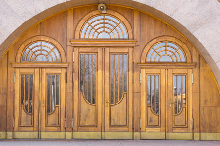 A closeup of an ornate arched wooden door of a church