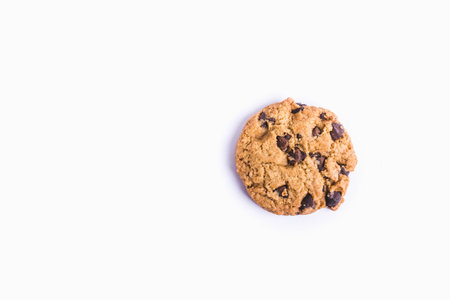 A closeup shot of a chocolate chip cookie isolated on a white backgroundの写真素材