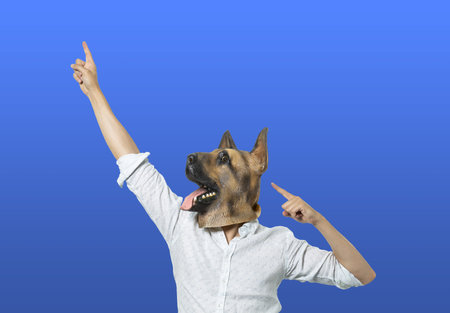 A male in a dog mask expressing happiness with hand gesturesの写真素材