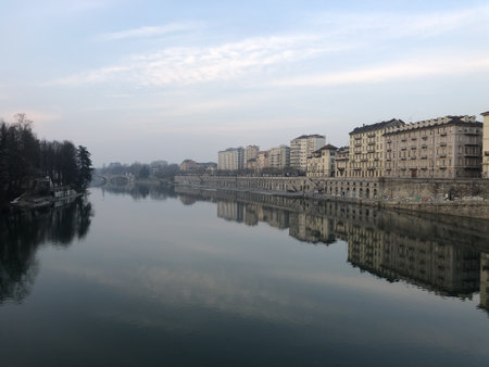 TURIN, ITALY - Feb 01, 2020: A wide angle shot of the Po river in the Murazzi district of Italy surrounded by buildingsのeditorial素材
