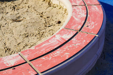 A selective focus shot of a pool of sand at the playground