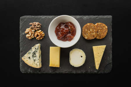 A top view of an assortment of delicious snacks served on a board