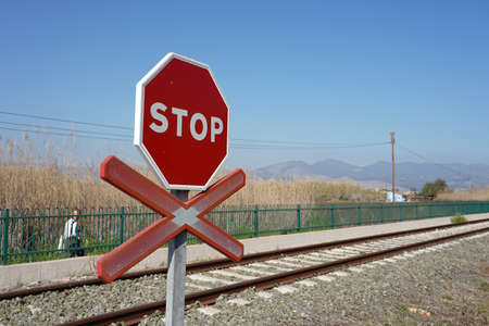 A stop warning sign on the rails in the stationの写真素材