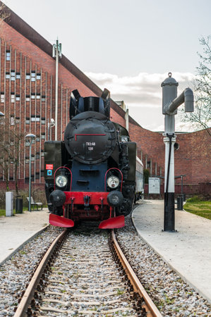 POZNAN, POLAND - Mar 22, 2020: Front of a old exposition locomotive on a track in the Rataje park.のeditorial素材