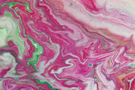 A closeup shot of abstract patterns created with bright paints mixed in the water