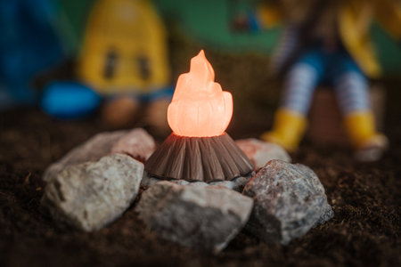 A closeup shot of a toy bonfire in a toy hiking camp