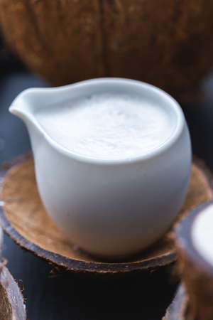 A closeup shot of a cup of creamy coconut milkの写真素材