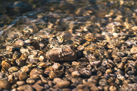 The stones under the transparent water in the sea