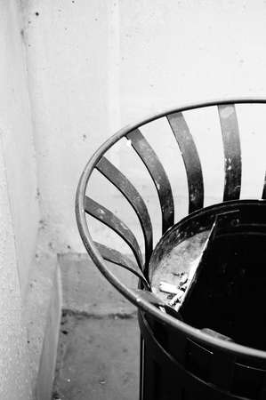A vertical shot of a circular metal trash can in a building