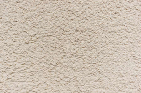A closeup shot of a textured beige wall-a good backgroundの写真素材